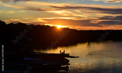 sunset in the Rumococha community, people are observed watching the sunset from a boat © JulietK
