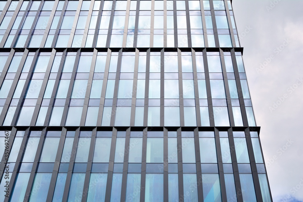 Facade texture of a glass mirrored office building. Fragment of the facade. Modern architecture of the office building. Facade texture of a glass mirrored office building. Fragment of the facade. Modern architecture of the office building.