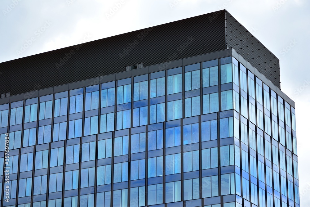 Facade texture of a glass mirrored office building. Fragment of the facade. Modern architecture of the office building. Facade texture of a glass mirrored office building. Fragment of the facade. Modern architecture of the office building.