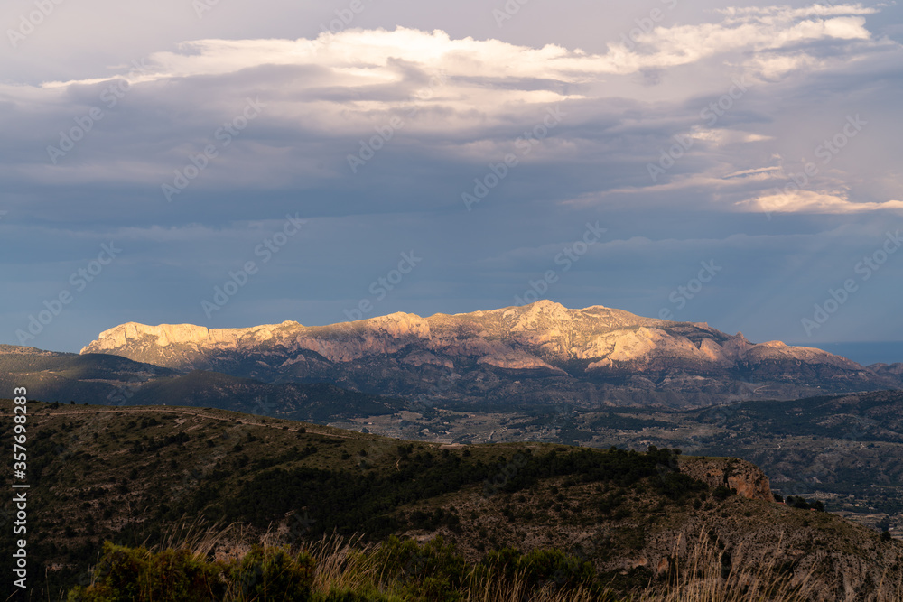 Sierra de los planes mountain illuminated by the sun at sunset