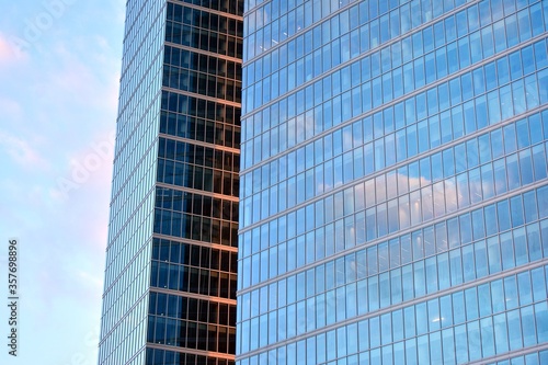 Facade texture of a glass mirrored office building. Fragment of the facade. Modern architecture of the office building.