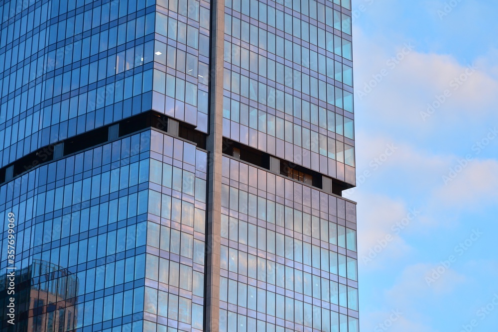 Facade texture of a glass mirrored office building. Fragment of the facade. Modern architecture of the office building. Facade texture of a glass mirrored office building. Fragment of the facade. Modern architecture of the office building.