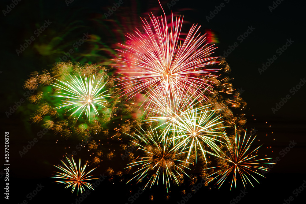Bright colored fireworks on a festive night. Explosions of colored fire in the sky.