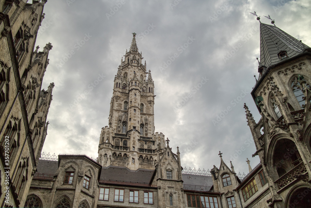 Old-fashioned architectural buildings against grey cloudy sky in Munich, Germany.