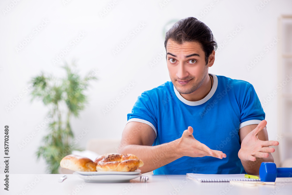 Young hungry man in dieting concept Young hungry man in dieting concept