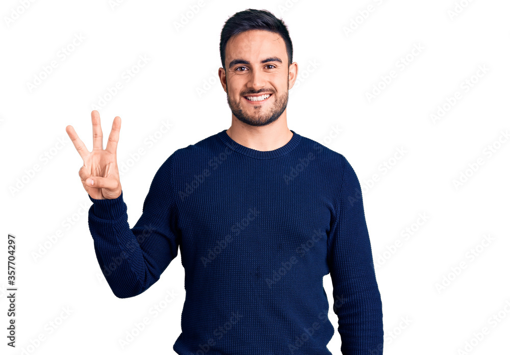 Young handsome man wearing casual clothes showing and pointing up with fingers number three while smiling confident and happy. Young handsome man wearing casual clothes showing and pointing up with fingers number three while smiling confident and happy.