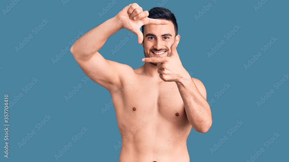 Young handsome man wearing swimwear smiling making frame with hands and fingers with happy face. creativity and photography concept.