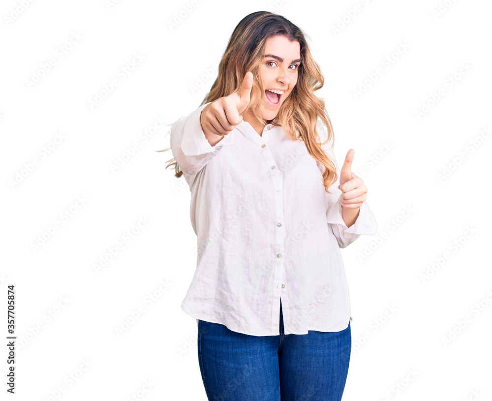 Young caucasian woman wearing casual clothes approving doing positive gesture with hand, thumbs up smiling and happy for success. winner gesture. Young caucasian woman wearing casual clothes approving doing positive gesture with hand, thumbs up smiling and happy for success. winner gesture.