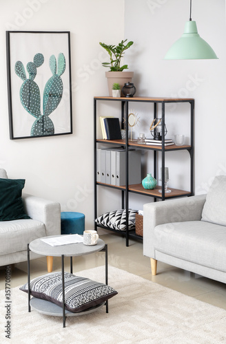 Stylish sofas, table and rack in interior of living in room