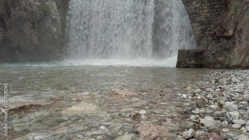 Amazing tilt up slow motion waterfall. The arch bridge waterfall of Paleokaria, Trikala, Thessaly, Greece photo