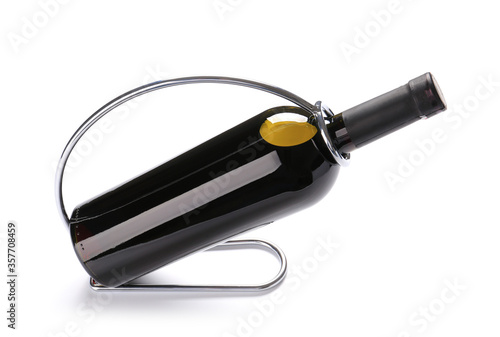 Holder with bottle of wine on white background