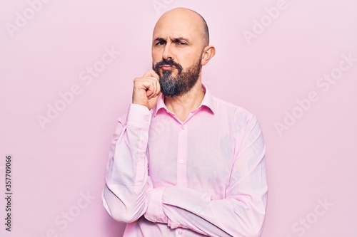 Young handsome man wearing business clothes serious face thinking about question with hand on chin, thoughtful about confusing idea