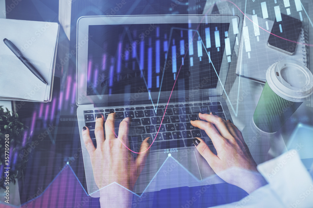 Double exposure of woman hands typing on computer and forex chart hologram drawing. Stock market invest concept.