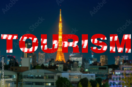 Inscription tourism is tied with a prohibition tape. Concept - ban on traveling around the world. Logo tourism on the background of the night city. Inscription symbolizes the closure of the front.