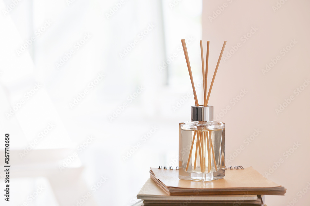 Reed diffuser and notebooks in room Reed diffuser and notebooks in room