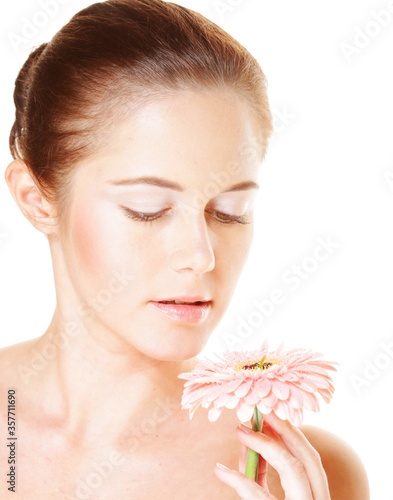 girl with cloused eyes holding flower photo