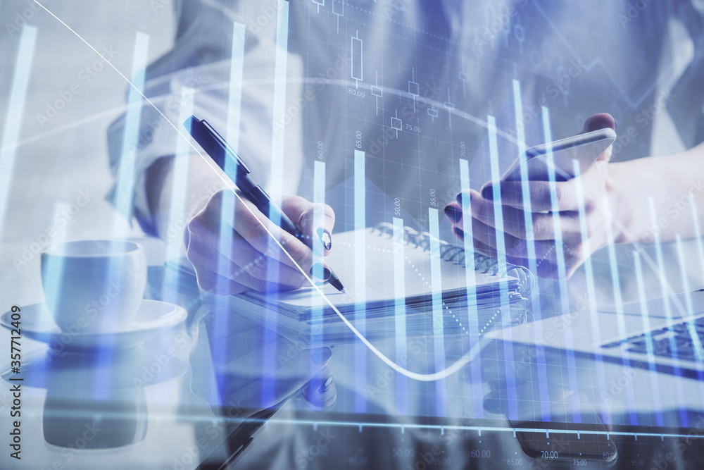 Double exposure of financial graph sketch hologram and woman holding and using a mobile device. Stock exchange concept. Double exposure of financial graph sketch hologram and woman holding and using a mobile device. Stock exchange concept.