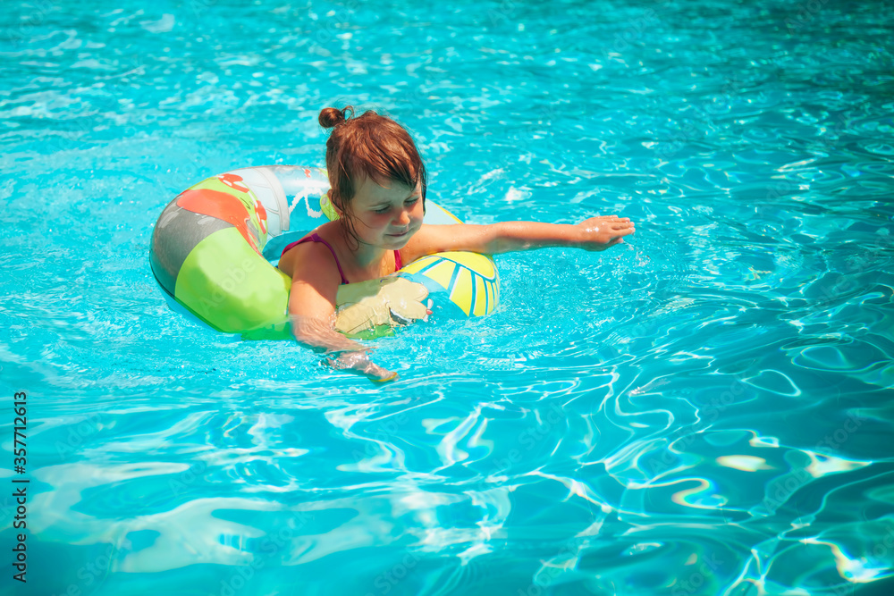 Summer vacation concept. Child having fun in swimming pool.