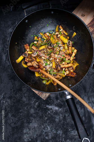 Vegan tofu, mushroom, pepper and squash stir fry in wok