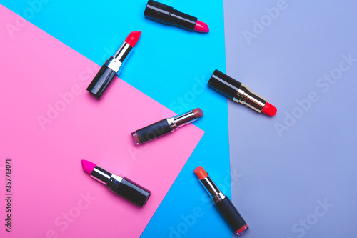 Set of lipsticks on color background