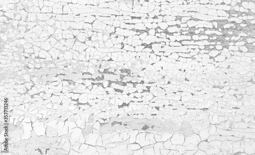 Old crackled black and white painted surface. Vintage wooden wall or floor with cracked paint.