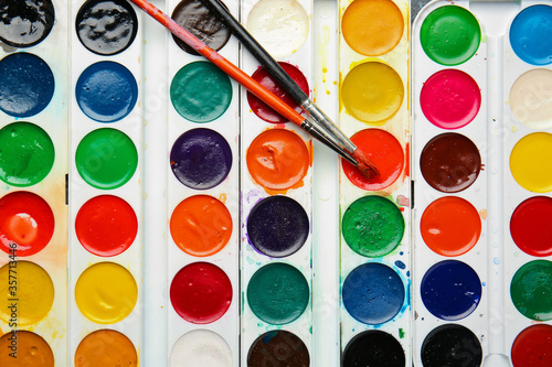 Palette of paints and brushes, top view