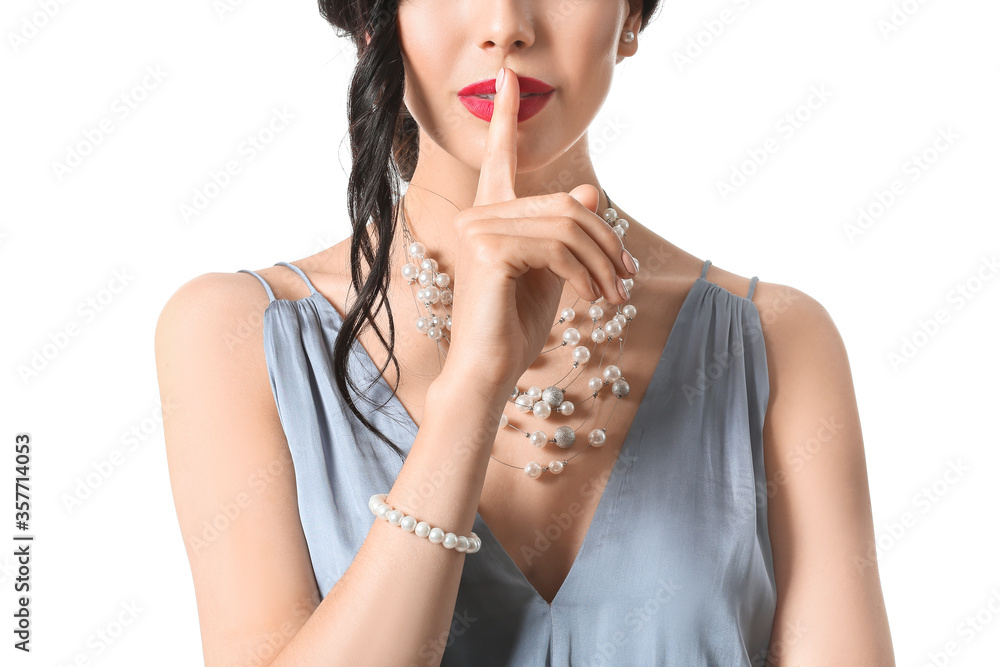 Fototapeta premium Beautiful young woman showing silence gesture on white background