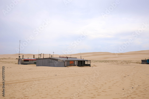 Tin fisherman's huts on wide sandy beach