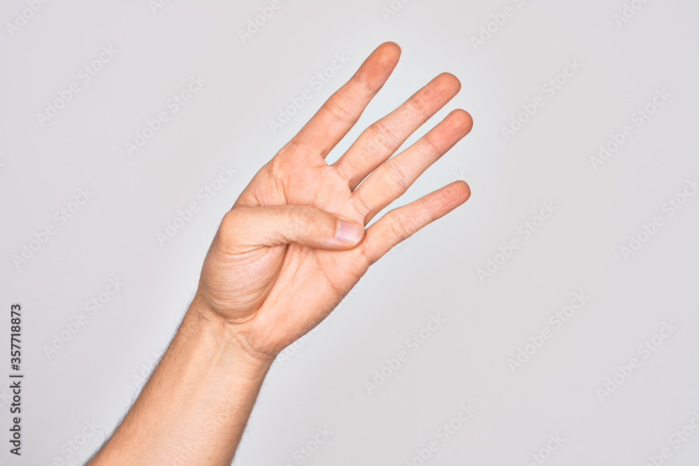 Hand of caucasian young man showing fingers over isolated white background counting number 4 showing four fingers Hand of caucasian young man showing fingers over isolated white background counting number 4 showing four fingers