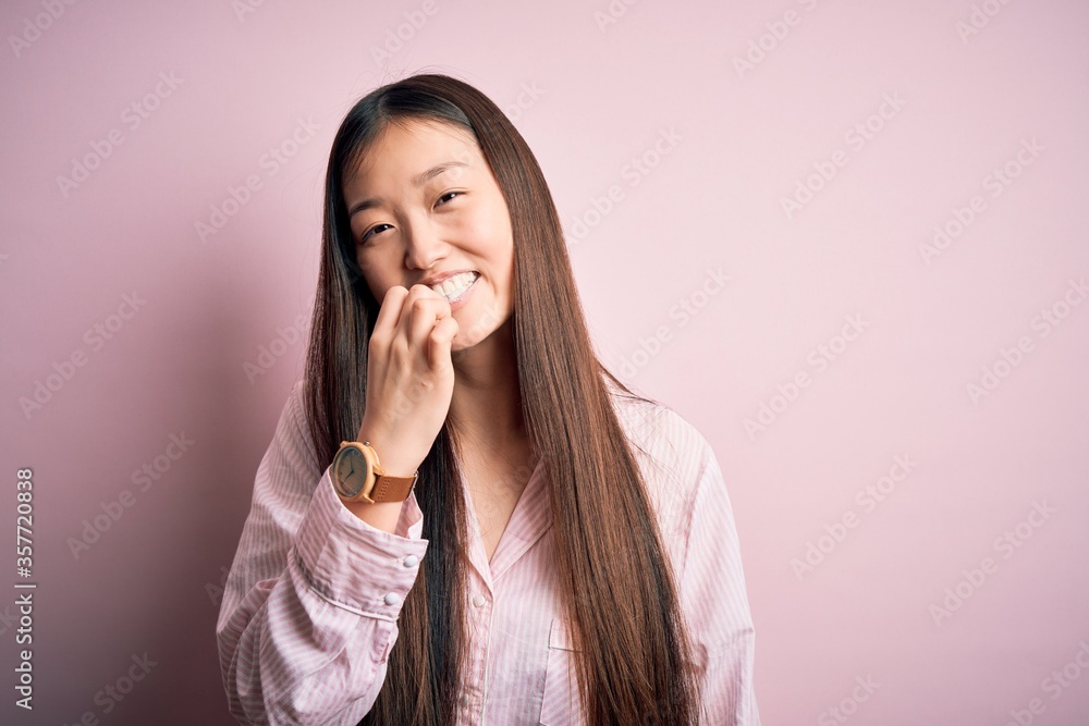 Young beautiful asian woman wearing pajama brushing her teeth using tooth brush and oral paste, cleaning teeth and tongue as healthy health care morning routine Young beautiful asian woman wearing pajama brushing her teeth using tooth brush and oral paste, cleaning teeth and tongue as healthy health care morning routine