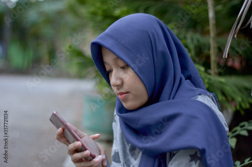 A girl texting in a smartphone 
