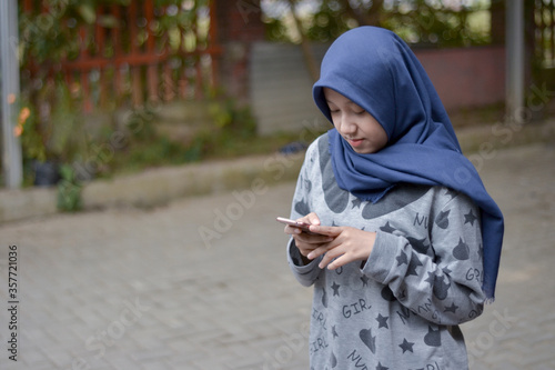 A girl texting in a smartphone 