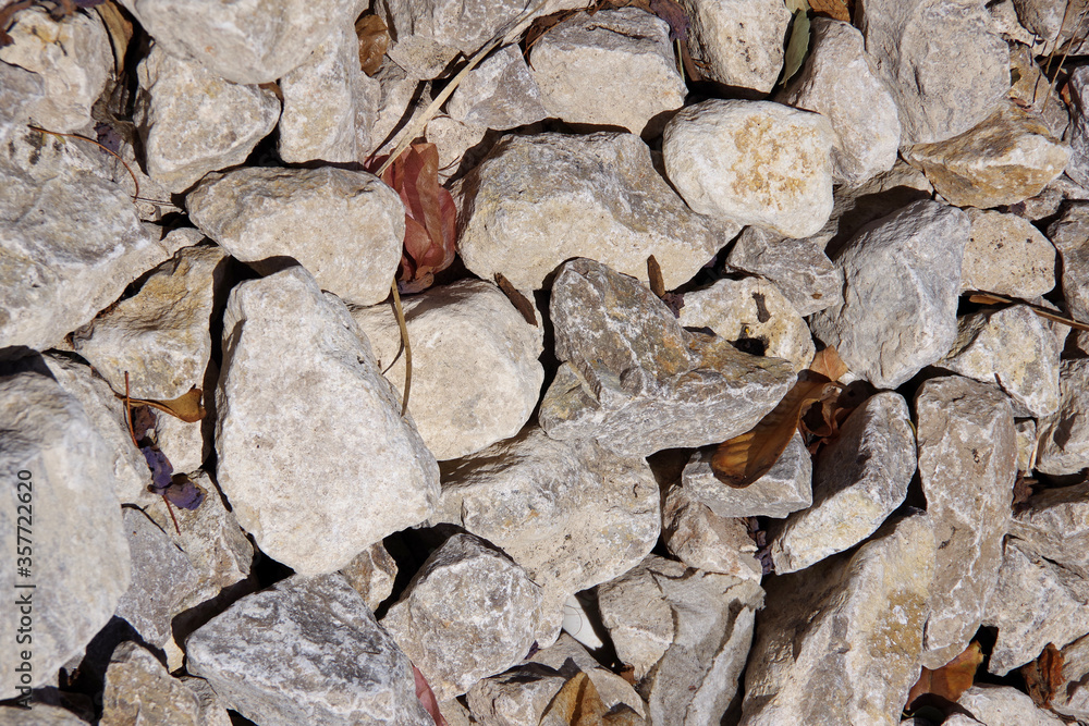 High angle full frame close-up view from directly above of rocks with some dried ficus leaves in between High angle full frame close-up view from directly above of rocks with some dried ficus leaves in between