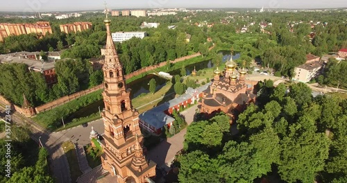 4K aerial summer morning high quality video footage of red brick Gefsimanskiy skit grand cathedral church with golden cupolas in small vintage town Sergiev Posad in Moscow Oblast in central Russia