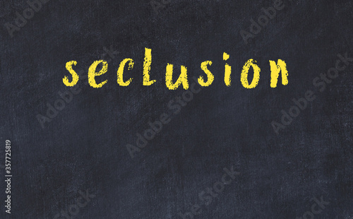 College chalk desk with the word seclusion written on in