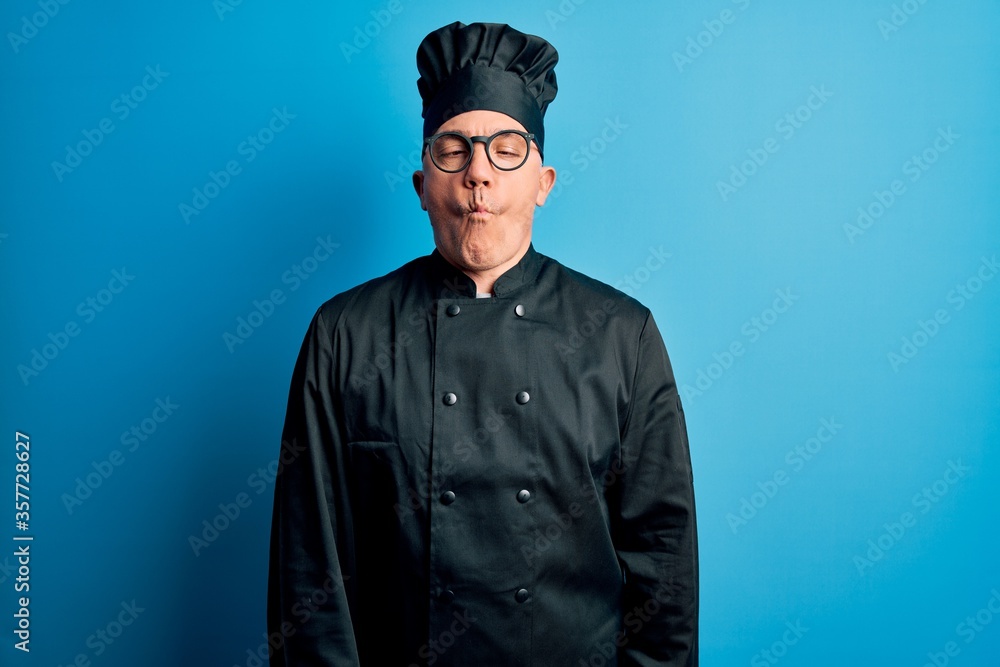 Middle age handsome grey-haired chef man wearing cooker uniform and hat making fish face with lips, crazy and comical gesture. Funny expression. Middle age handsome grey-haired chef man wearing cooker uniform and hat making fish face with lips, crazy and comical gesture. Funny expression.