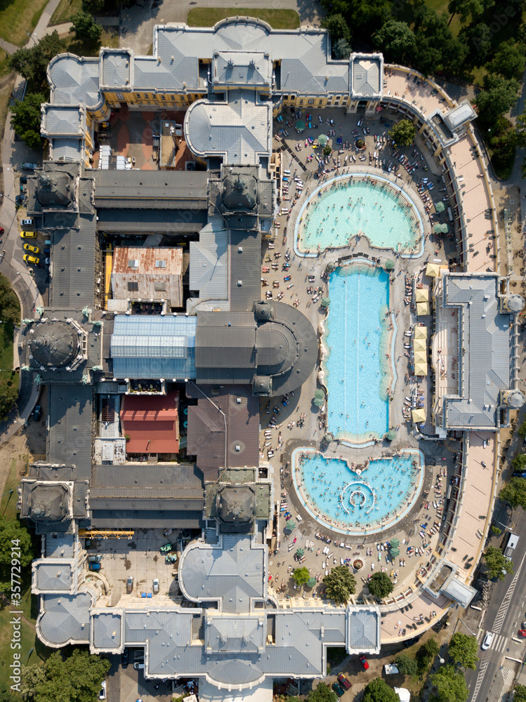Budapest / Hungary - JUNE 01 2018: Aerial top down view of swimming pool Szechenyi Thermal Bath and Spa in Budapest city, Hungary. Europe. Neo baroque architecture, green park around building. Summer.