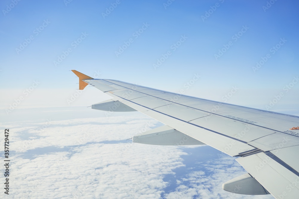 Fototapeta premium Cloudscape from window airplane, landscape of wing plane on a cloudy sky