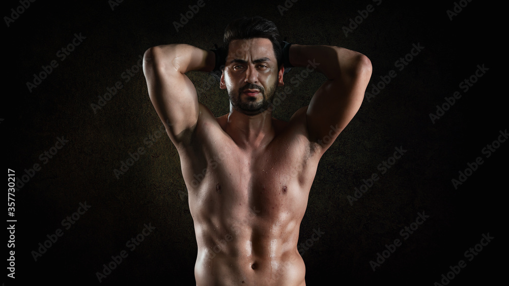athletics strong bodybuilder man posing show his muscle in gym