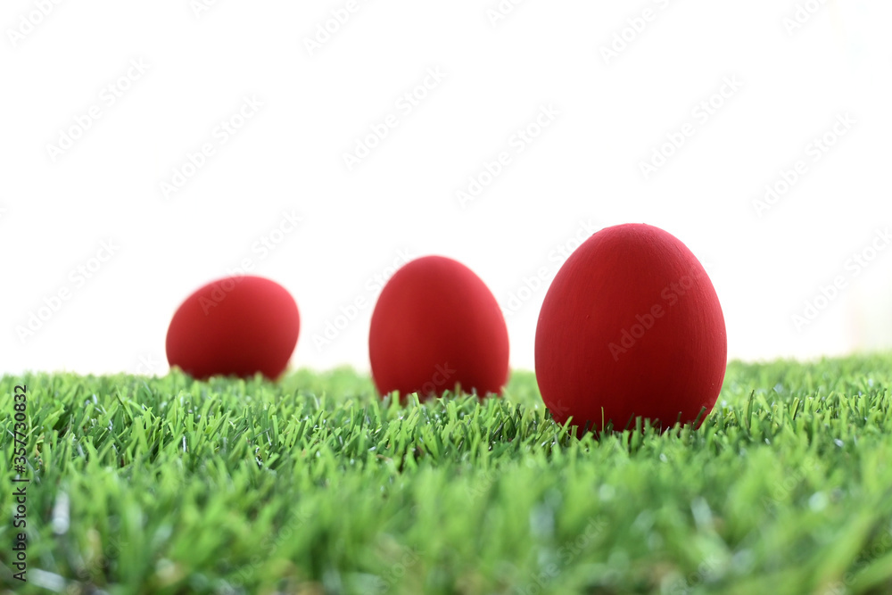 red easter egg on lawn green grass artificial with blank white background