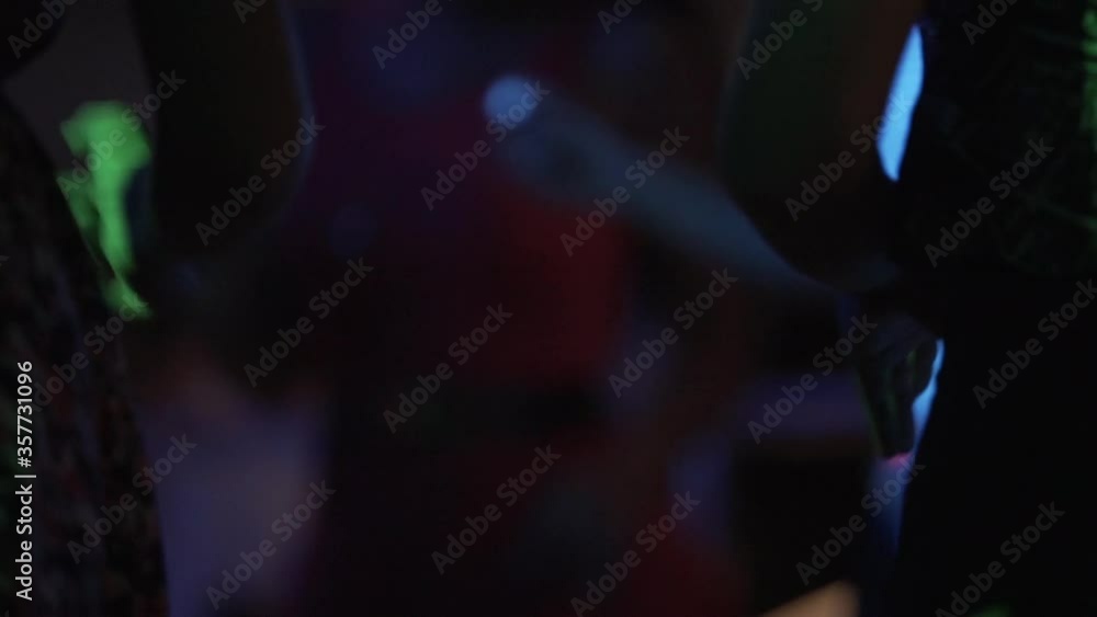 extreme close up of low part of women body dancing at a party in a nightclub , party lights amazing lifestyle extreme close up of low part of women body dancing at a party in a nightclub , party lights amazing lifestyle