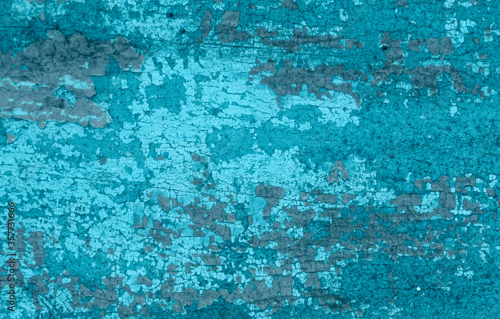 Old crackled teal turquoise painted wood surface. Vintage wooden wall or floor with cracked paint.