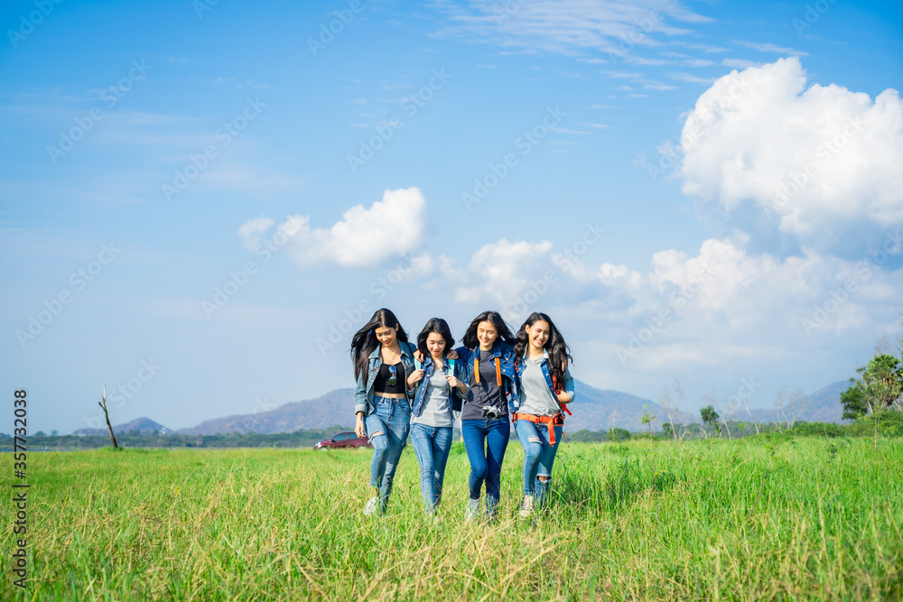A happy group of friends having fun travel through a wide field. Holidays and friendship. A happy group of friends having fun travel through a wide field. Holidays and friendship.