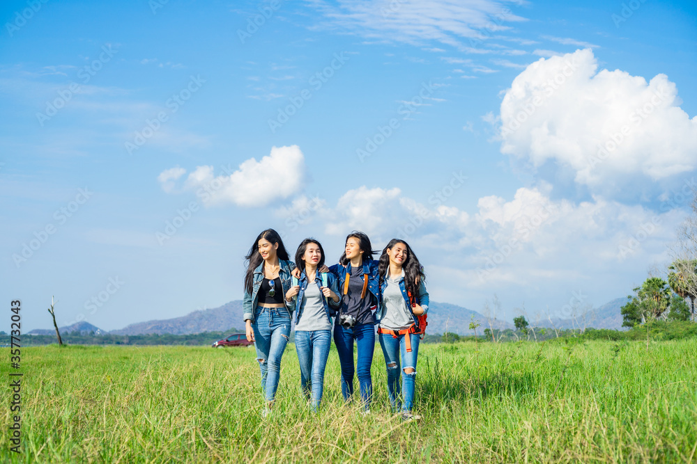 A happy group of friends having fun travel through a wide field. Holidays and friendship. A happy group of friends having fun travel through a wide field. Holidays and friendship.