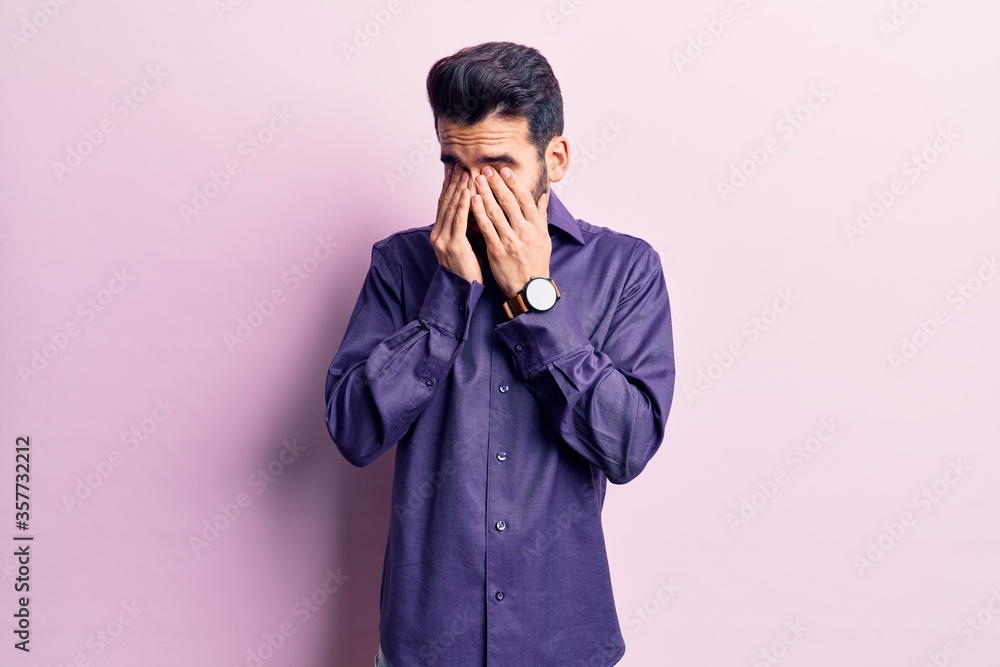 Young handsome man with beard wearing casual shirt rubbing eyes for fatigue and headache, sleepy and tired expression. vision problem Young handsome man with beard wearing casual shirt rubbing eyes for fatigue and headache, sleepy and tired expression. vision problem