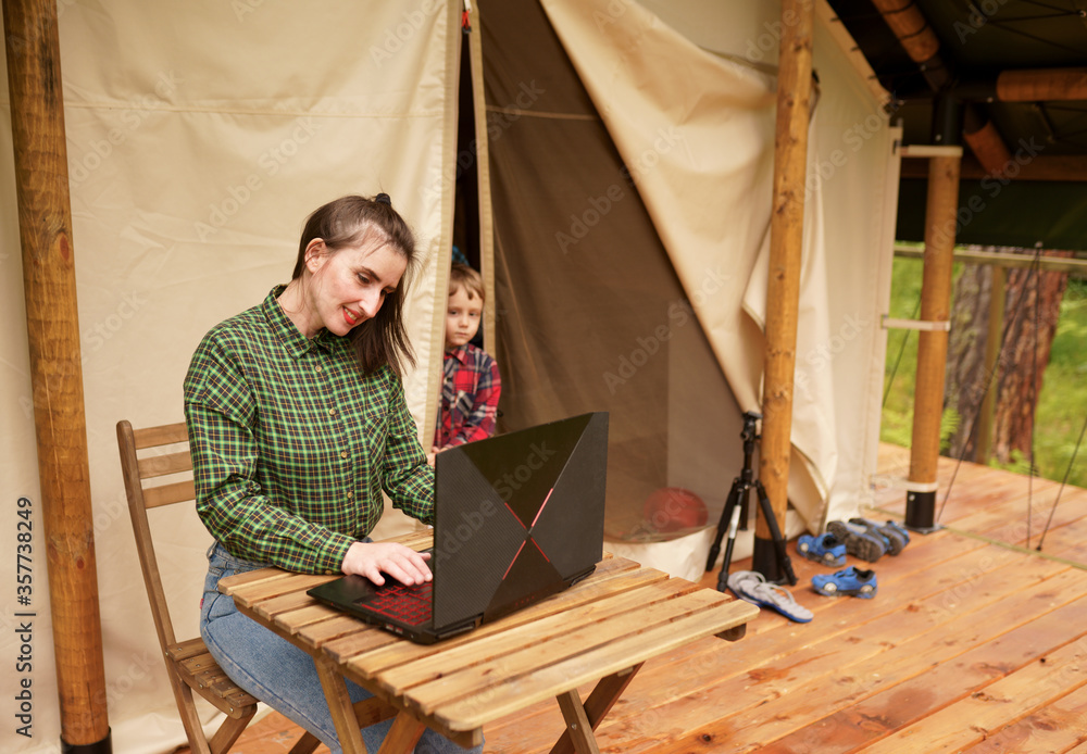 woman using laptop on the veranda woman using laptop on the veranda