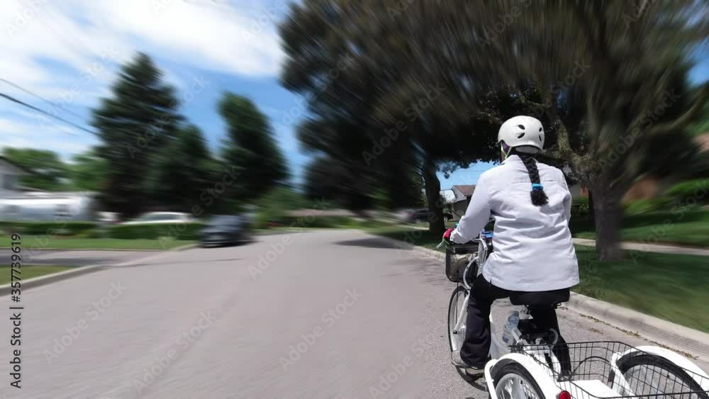 Cyclist riding an electric bicycle in the urban city area. Ecology concept. Shot from the side. Cyclist riding an electric bicycle in the urban city area. Ecology concept. Shot from the side.