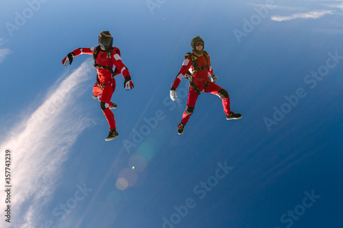 Two sports parachutist build a figure in free fall. Extreme sport concept. photo