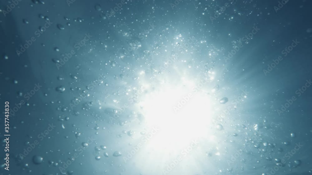 Underwater Bubbles with sunlight through water surface, natural slow motion under water scene Underwater Bubbles with sunlight through water surface, natural slow motion under water scene