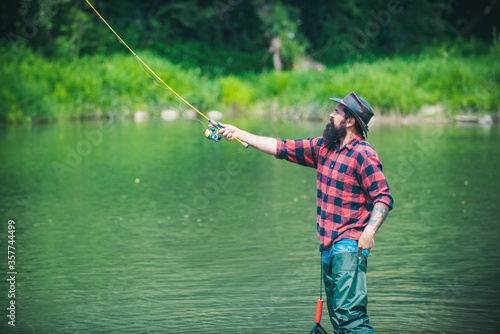 Fishing. Relax in natural environment. Cheerful mature fisherman fishing in a river outdoors. Fishing is fun. Home of hobbies. Fish on hook. Legend has retired. Just do that only.